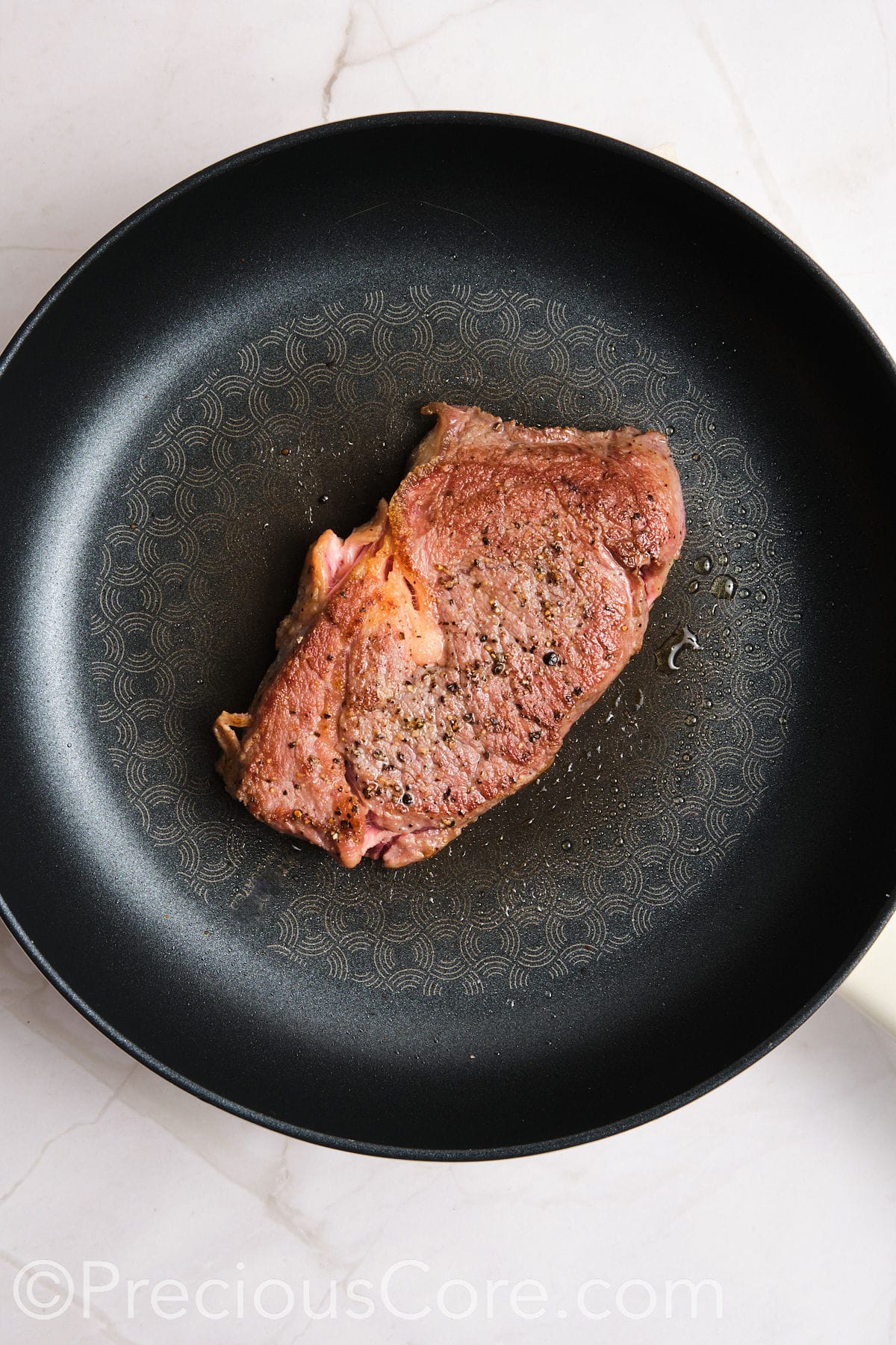 Steak cooked in a skillet.