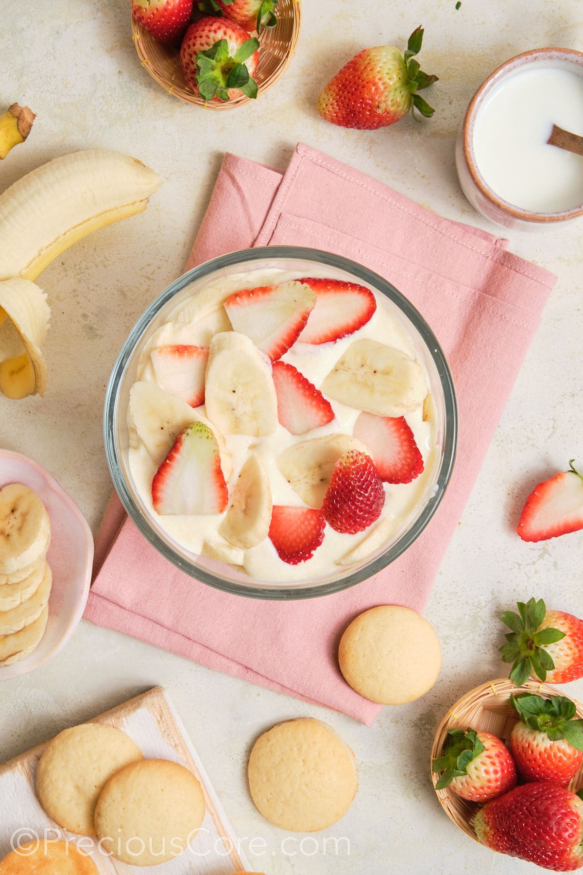 A layer of strawberries and bananas over pudding.