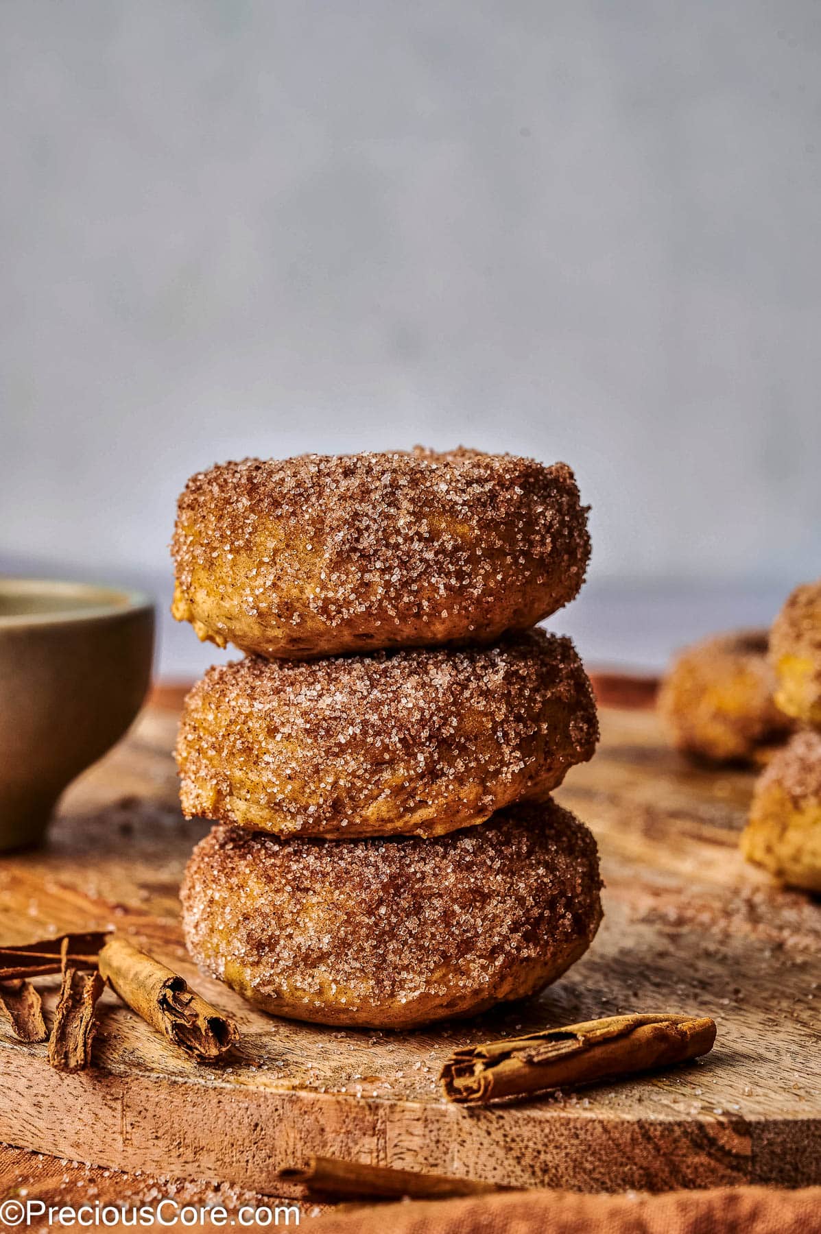 Pumpkin spice doughnuts stacked on each other.