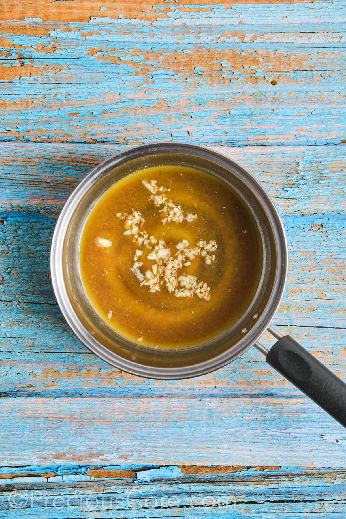 Making honey butter sauce in a small pot.