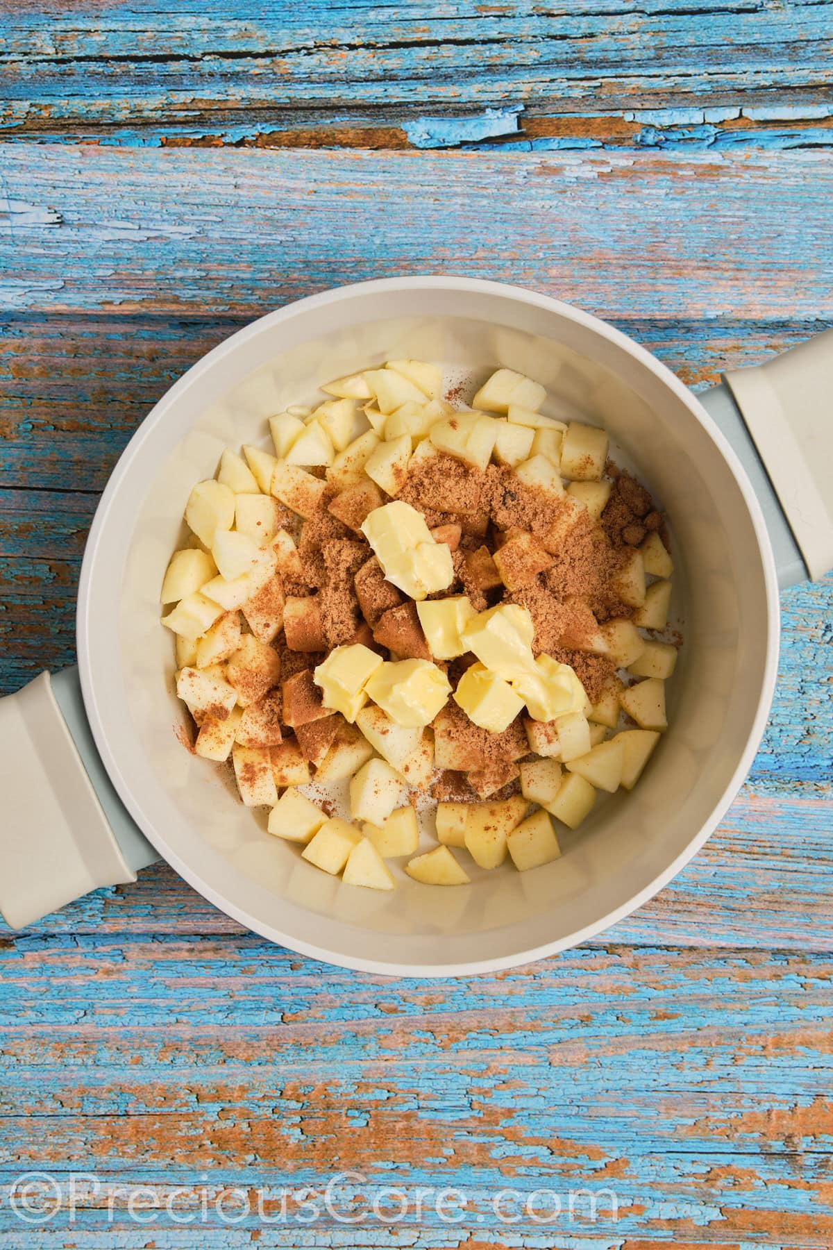 Ingredients for apple pie filling in a pot.