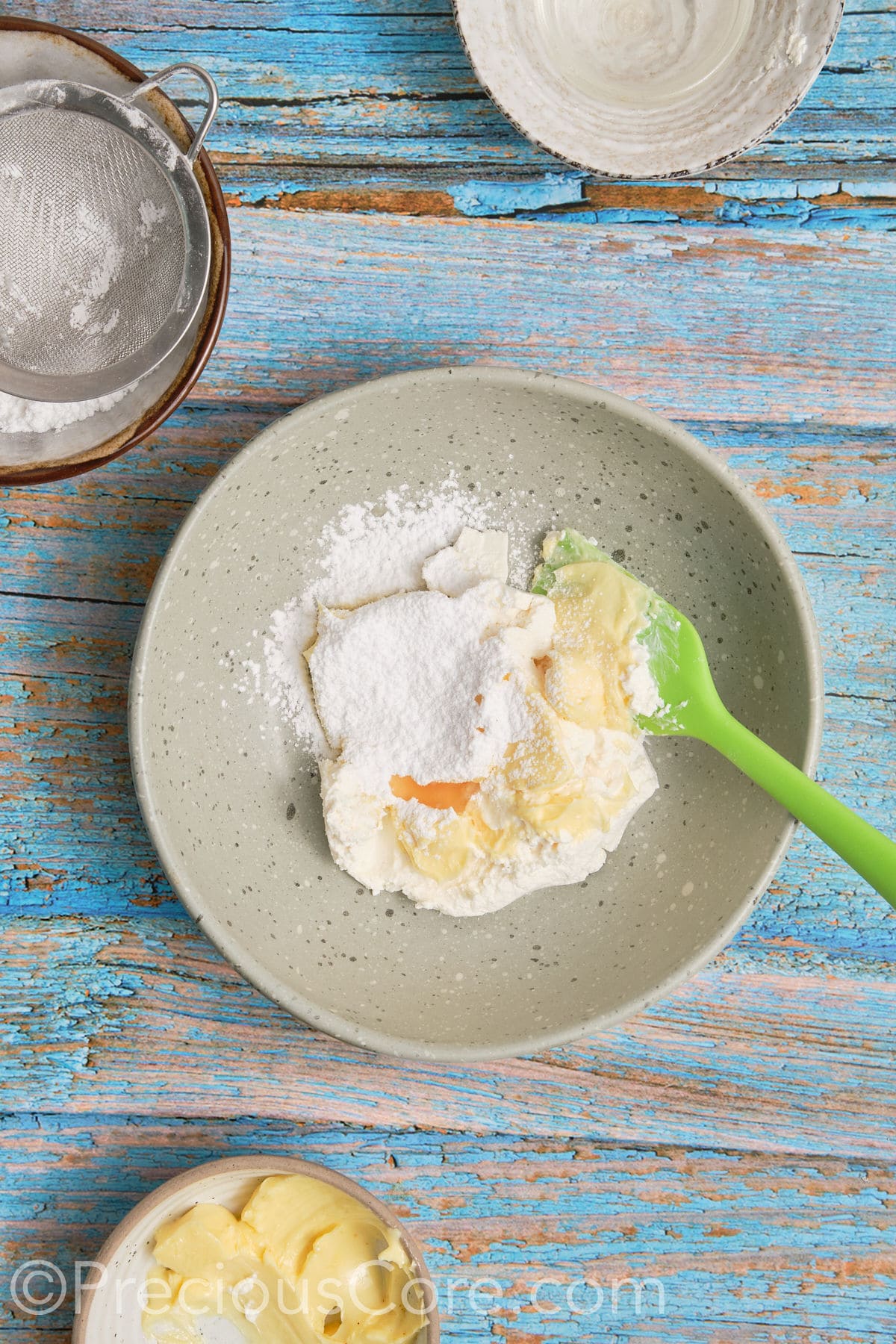 Ingredients for cream cheese frosting in a bowl.