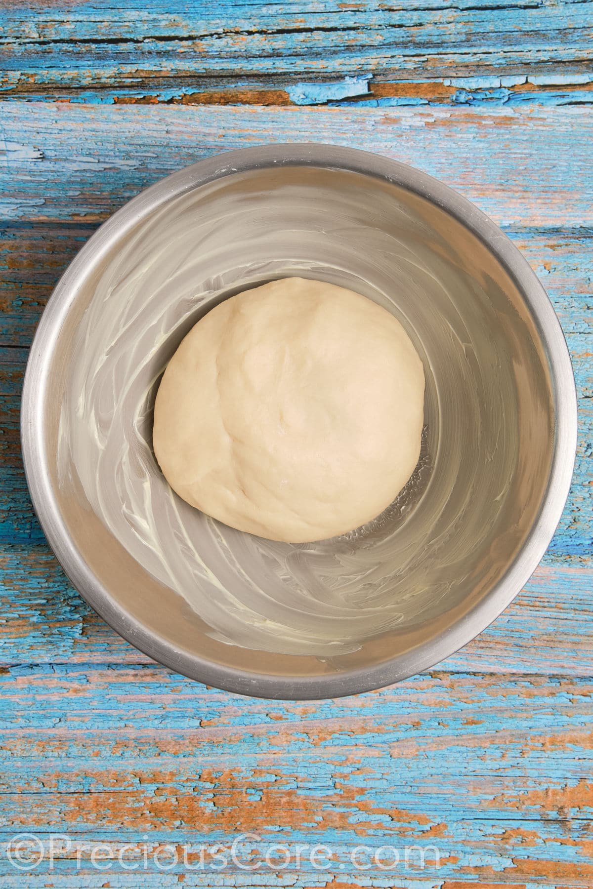 Dough in a buttered bowl.