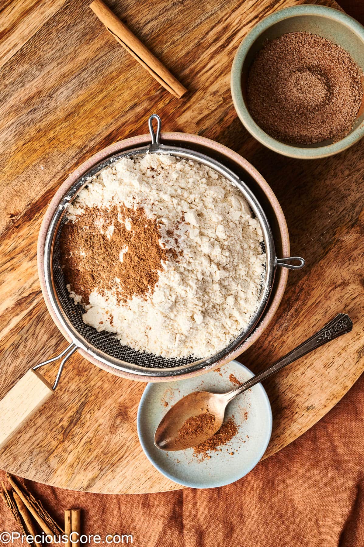 Sifting together flour and other ingredients.