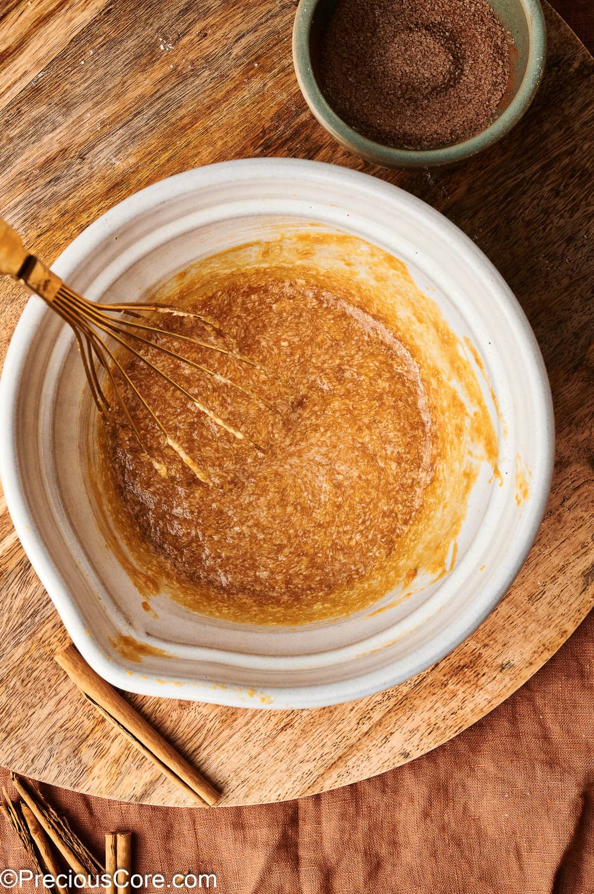 Whisked wet ingredients for pumpkin doughnuts or muffins.