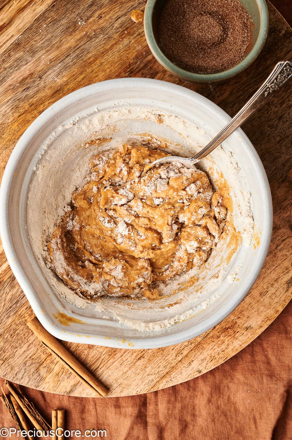 Mixing flour with pumpkin puree and other ingredients.