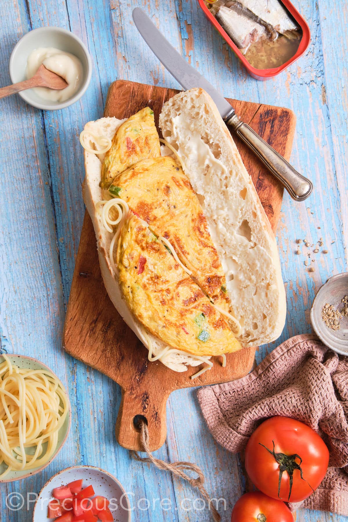 A French baguette open, one side laid with omelet.