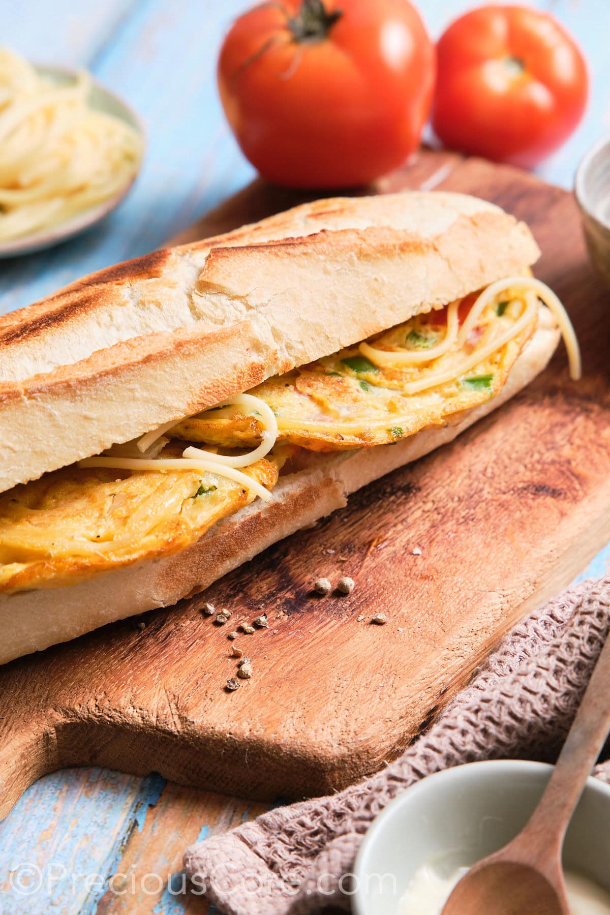 A full sandwich on a cutting board.