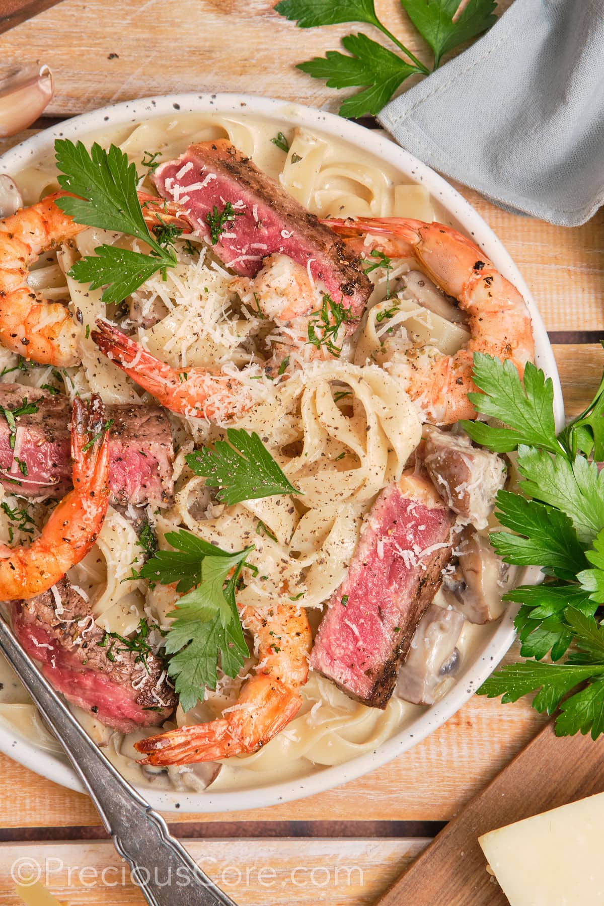 Creamy pasta topped with juicy steak and shrimp.