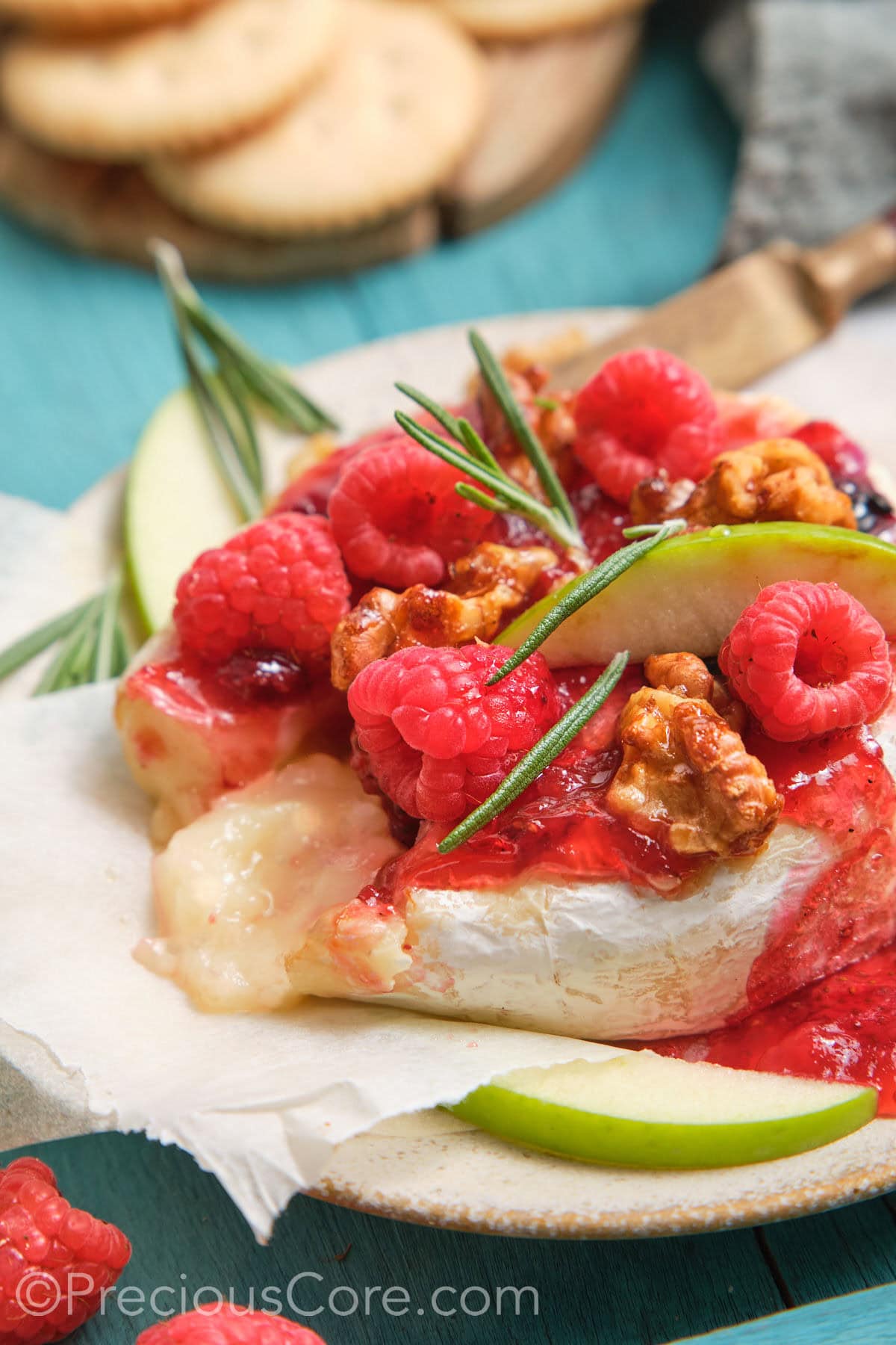 Served baked brie and preserves with melty cheese in the middle.