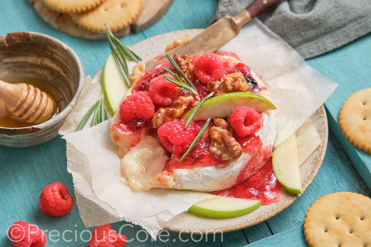 Round baked brie and fruit preserves.