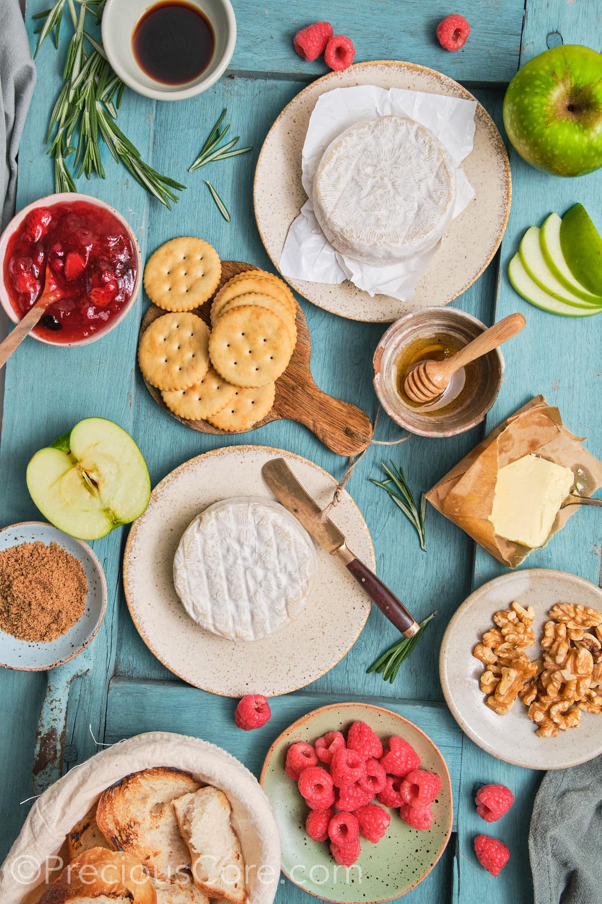 Baked brie and preserves ingredients on a board.