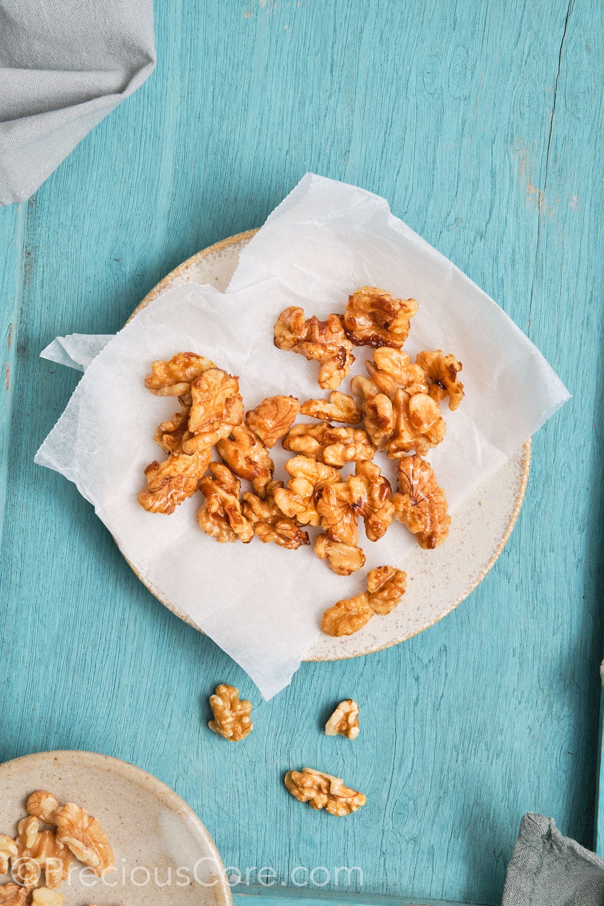 Walnuts placed on parchment paper to cool.