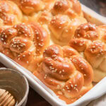 A baking dish of baked Challah Dinner Rolls.