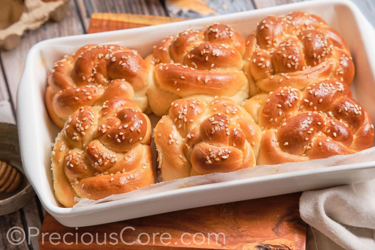 Landscape image of challah dinner rolls.