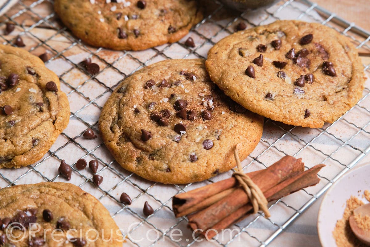 Landscape image of large cookies topped with chocolate chips.