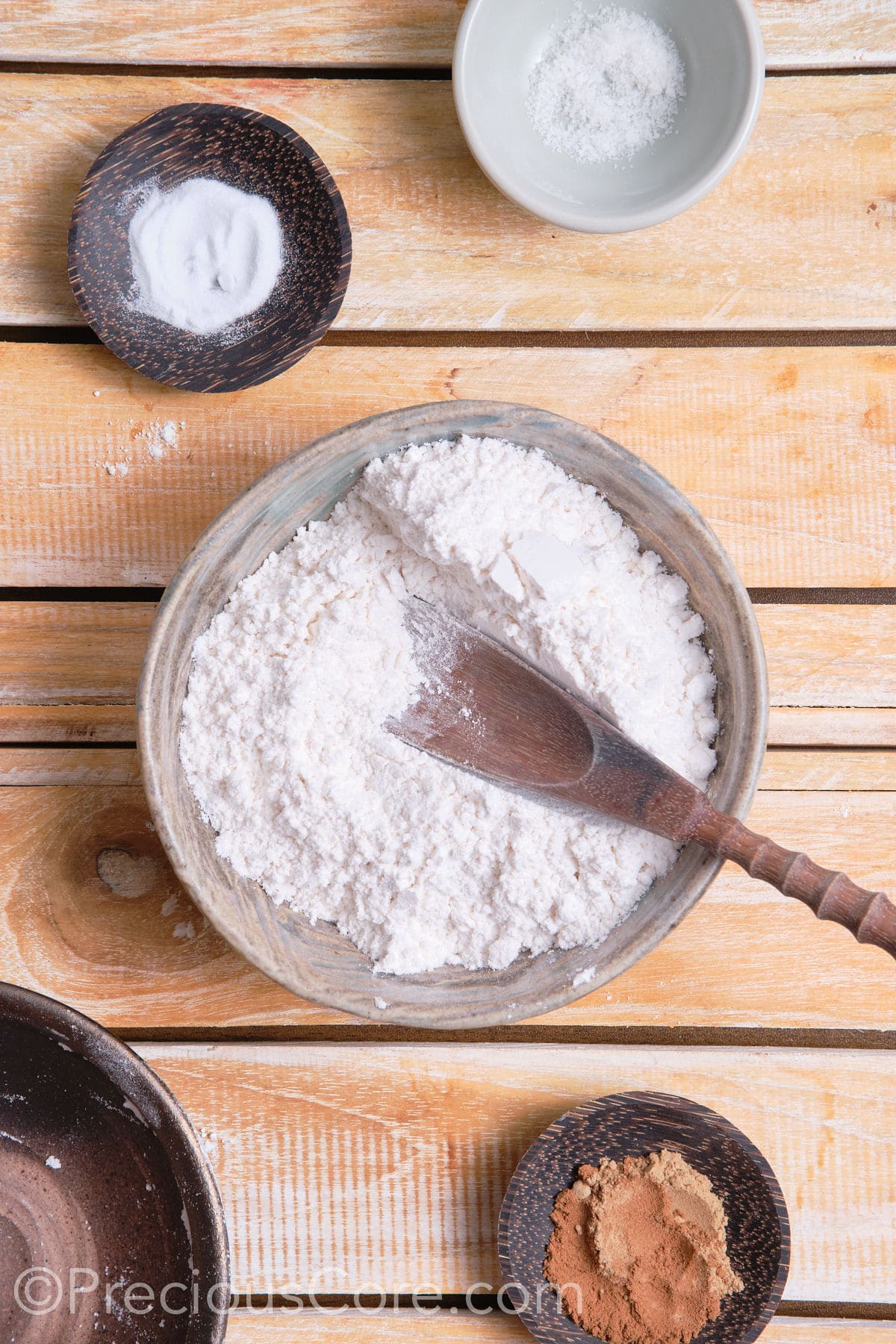 adding dry ingredients for the cookies to a bowl. 