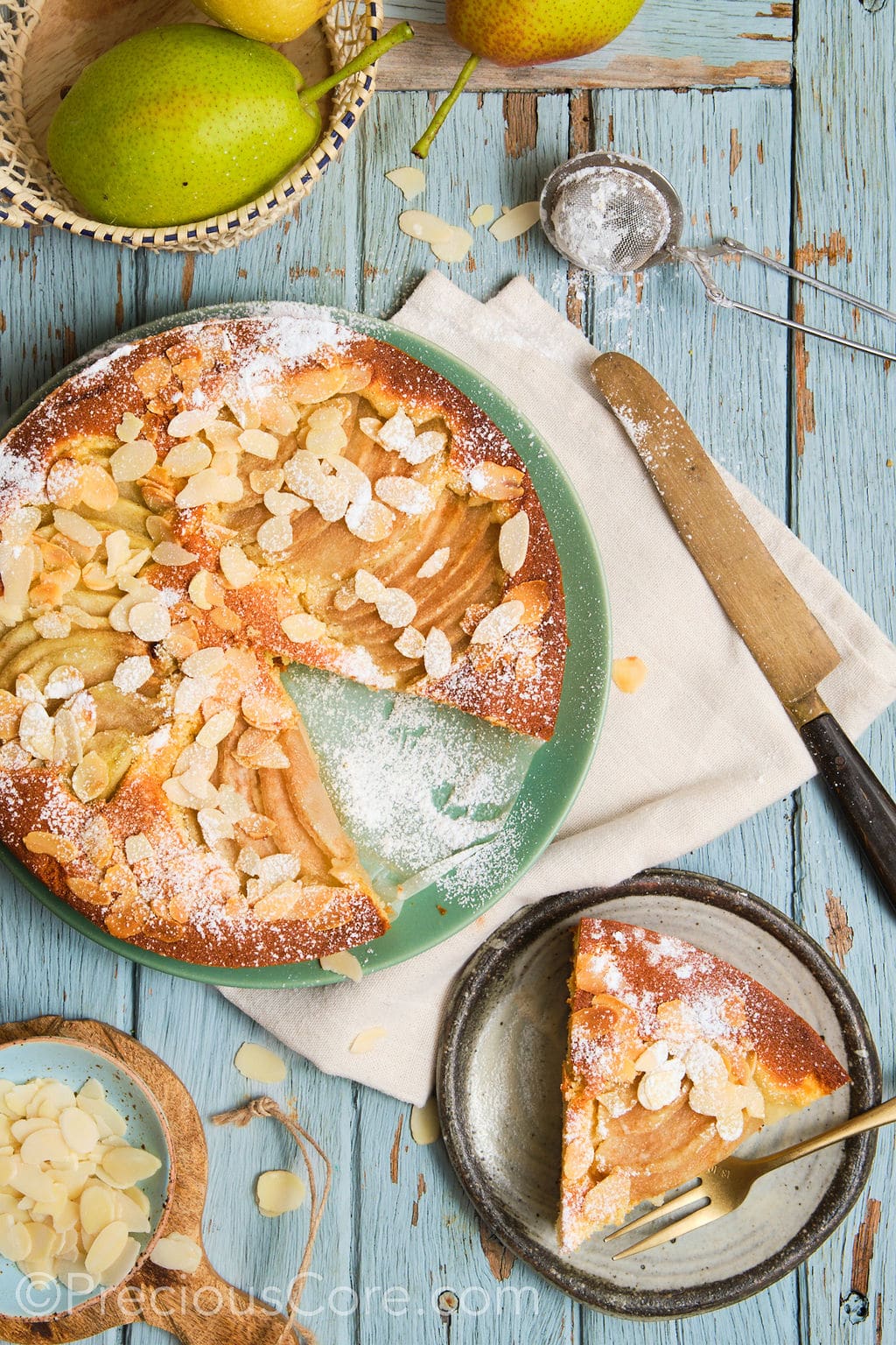 pear and almond cake, topped with a dusting of icing sugar, sliced and served. 