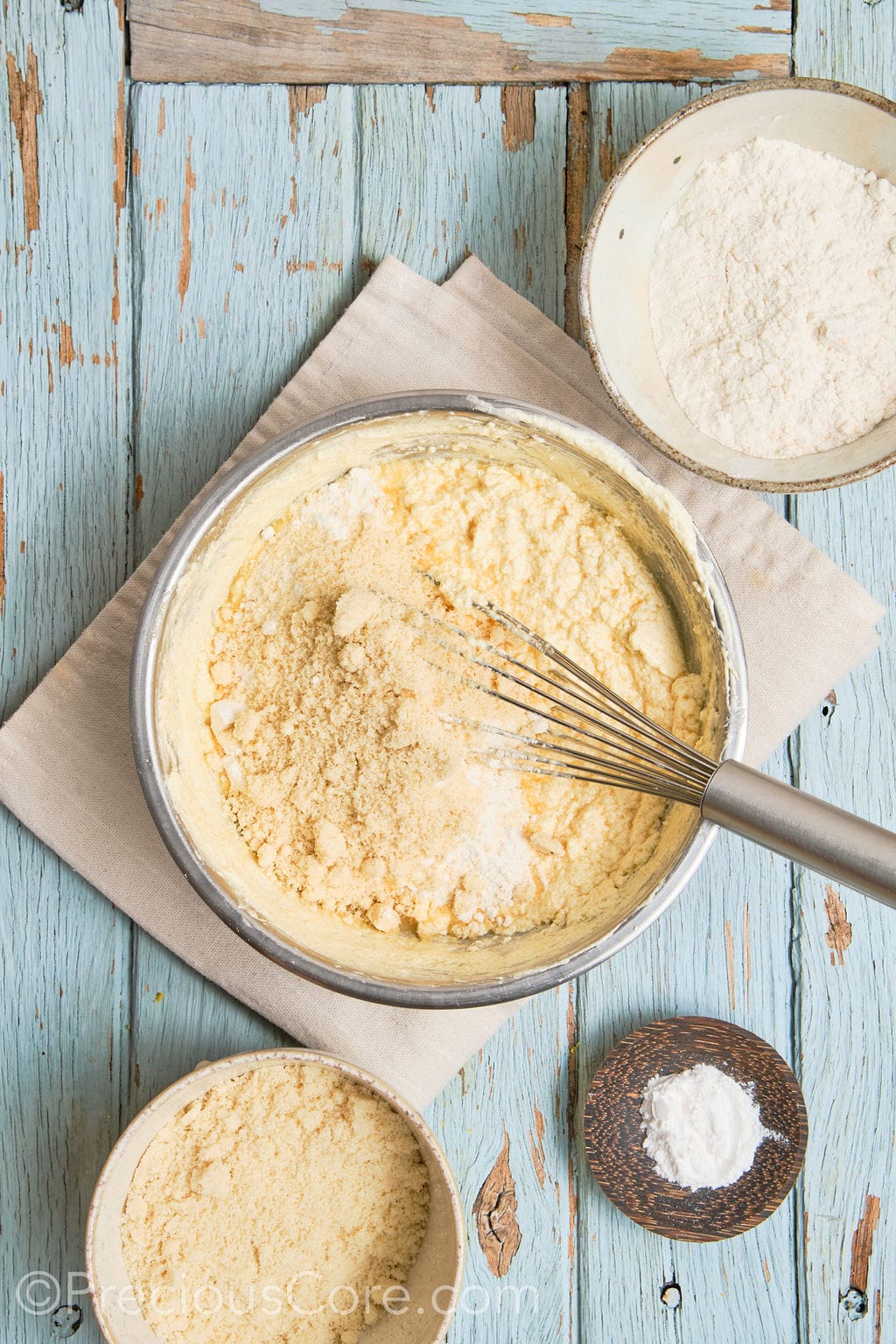 almond flour being whisked into the cake batter. 