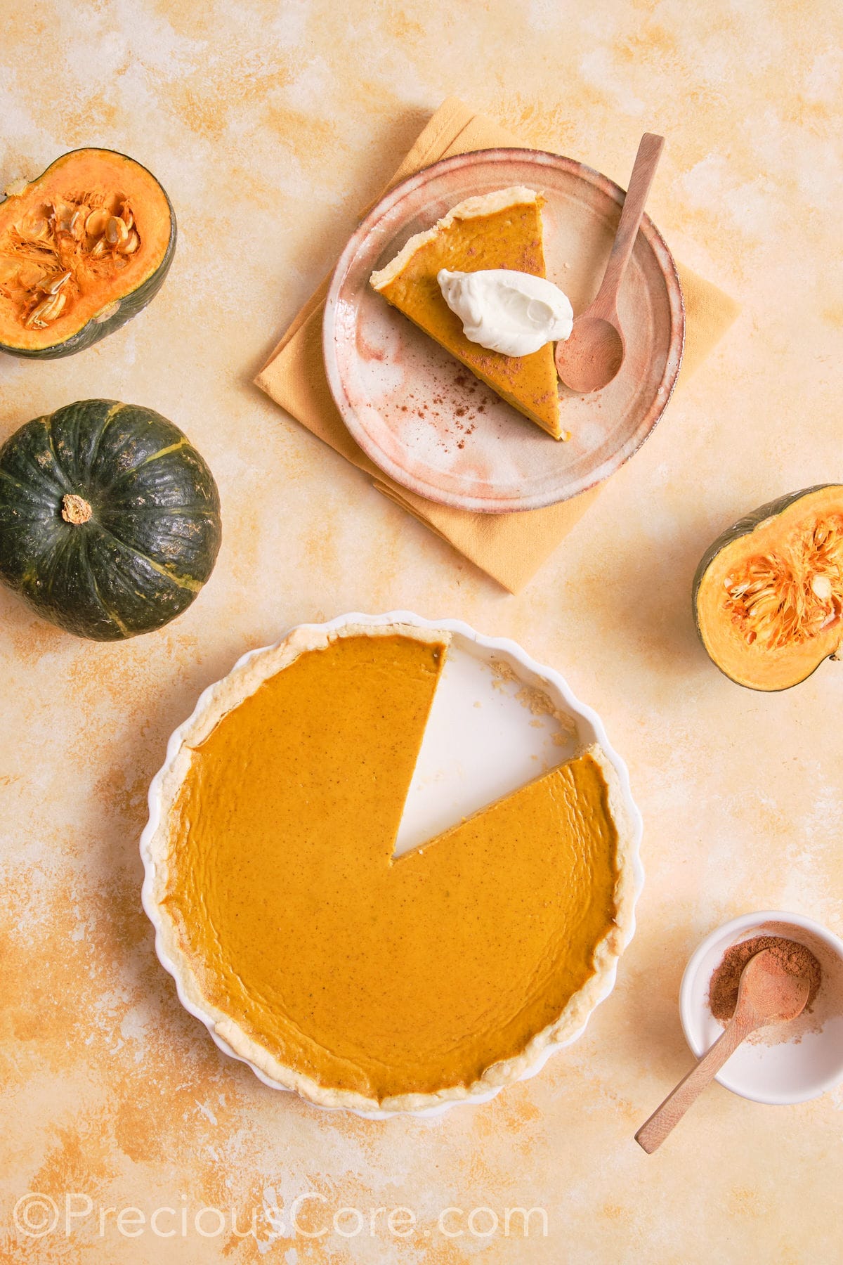 Pumpkin pie with a slice taken out.