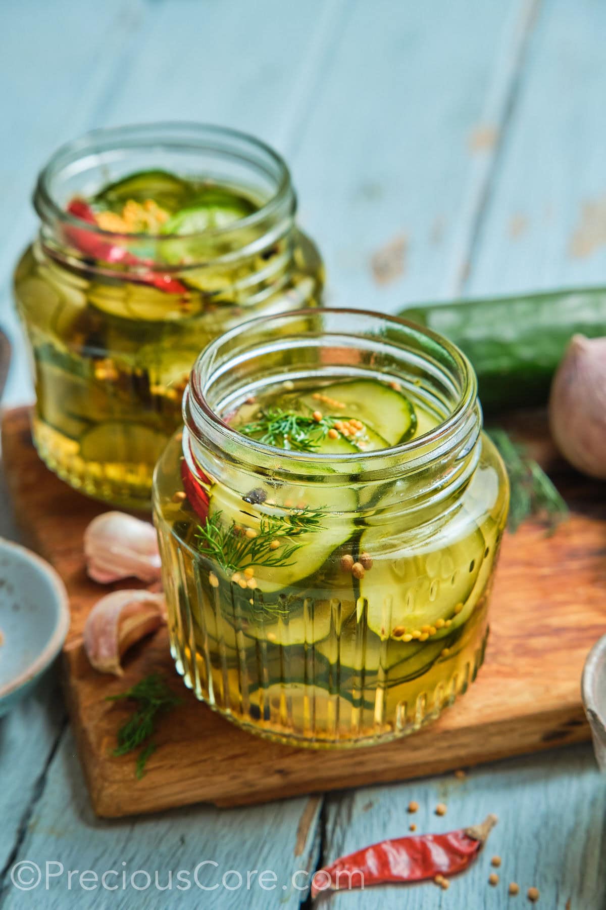 Two mason jars of homemade quick pickled cucumbers.