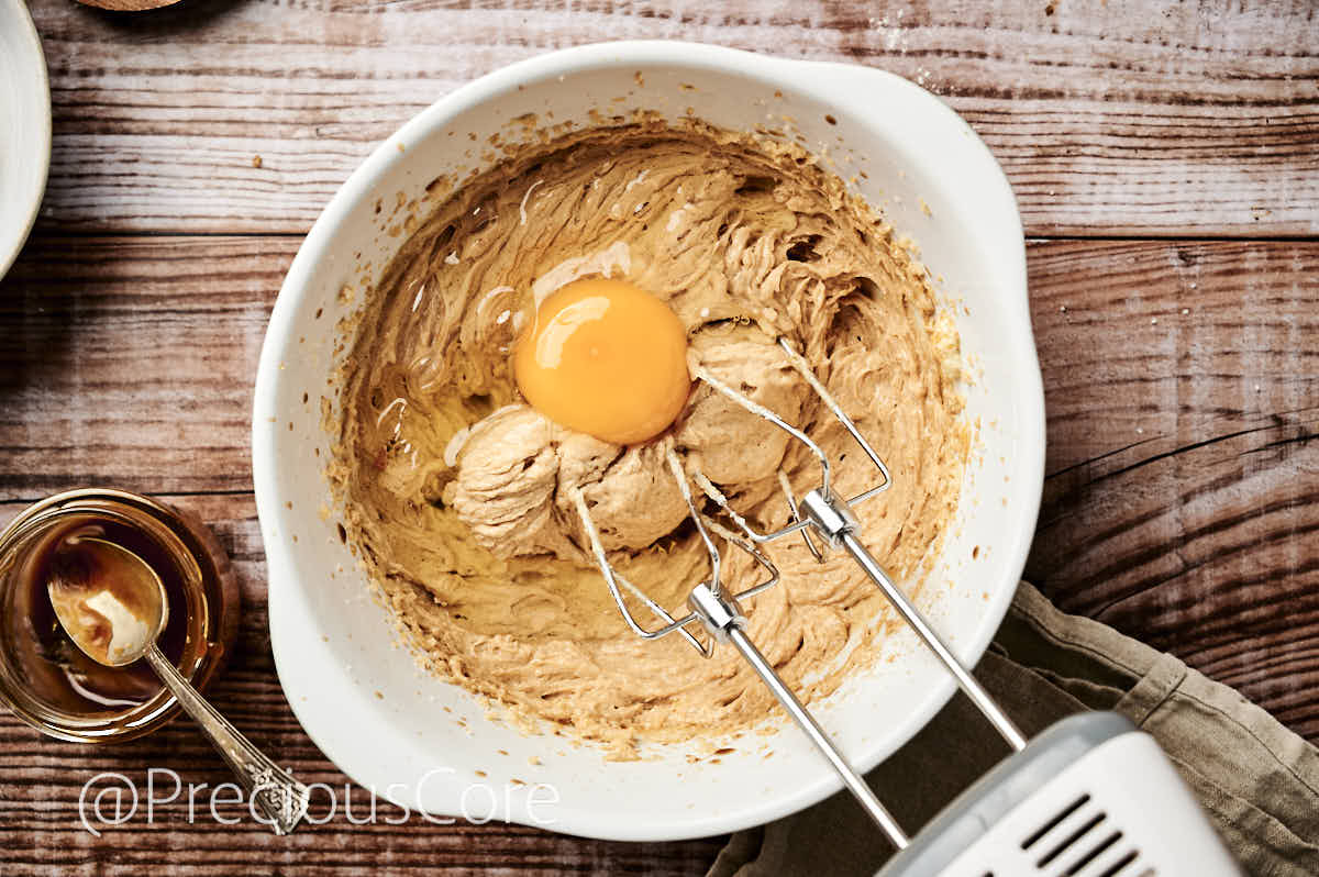 Adding eggs to butter mixture.