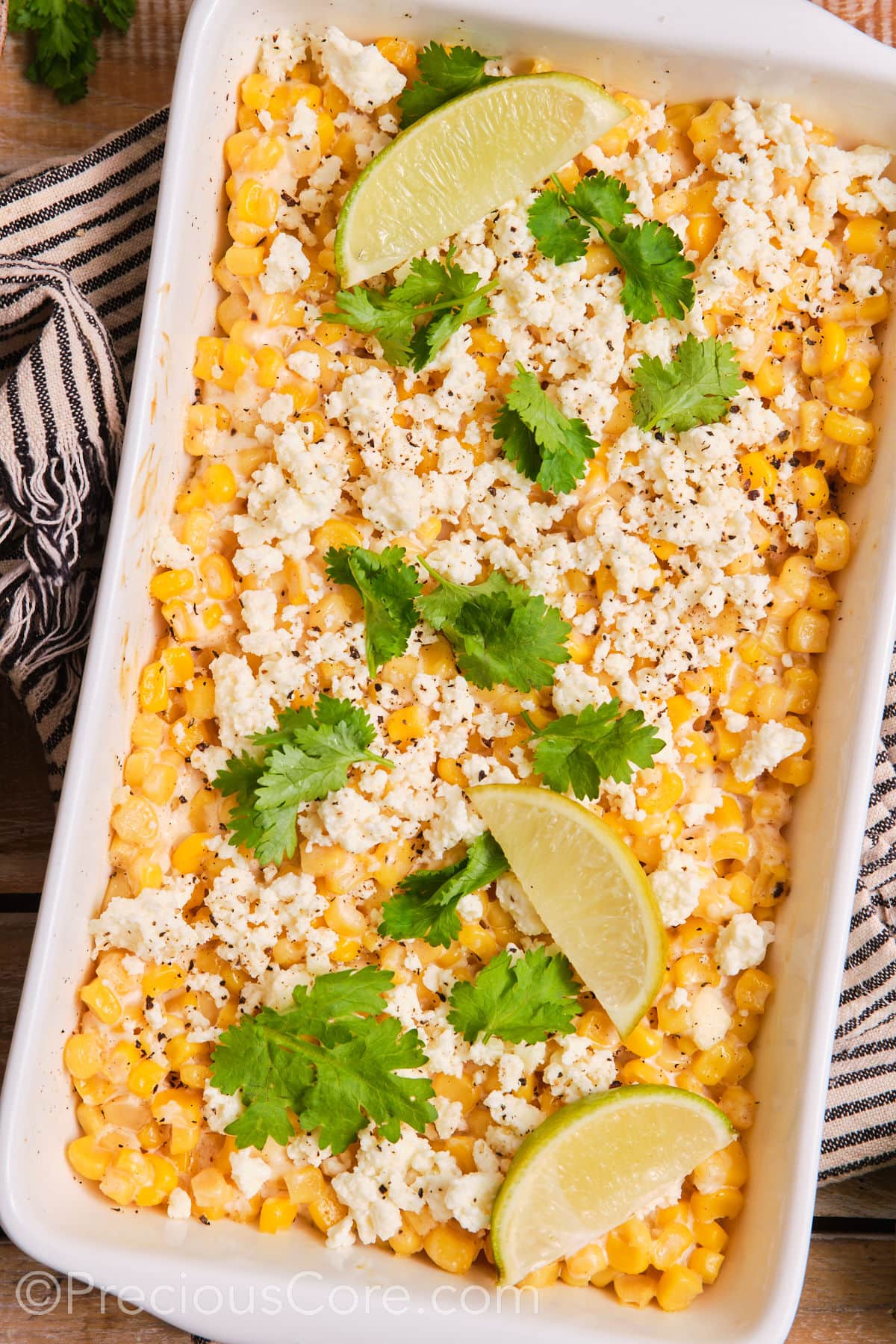 Mexican street corn casserole in a white baking dish.