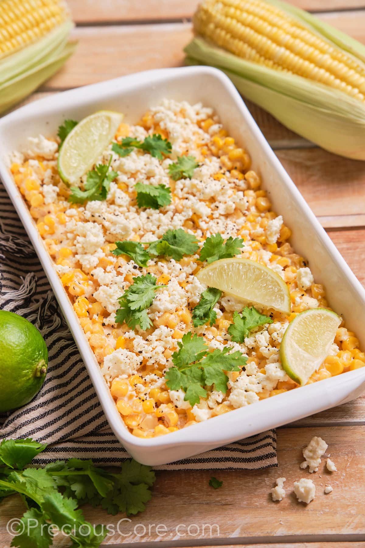 Street corn casserole in a white dish.