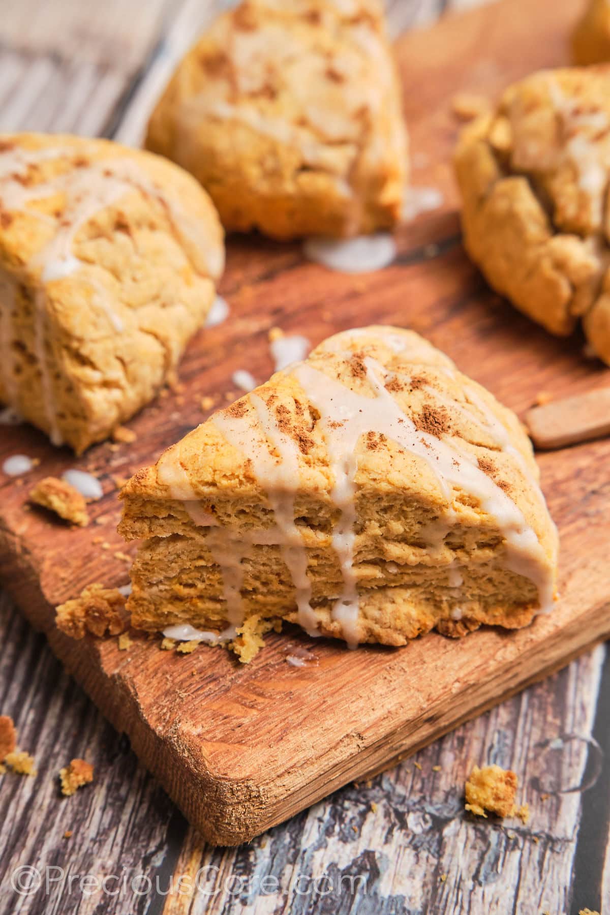 A triangle sweet potato scone with a white glaze on top.