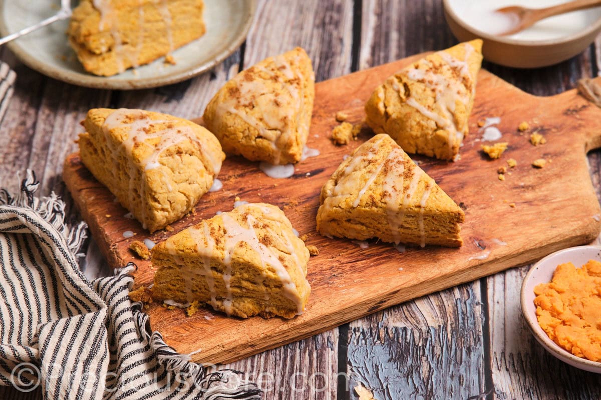 The most delicious scones on a wooden chopping board.