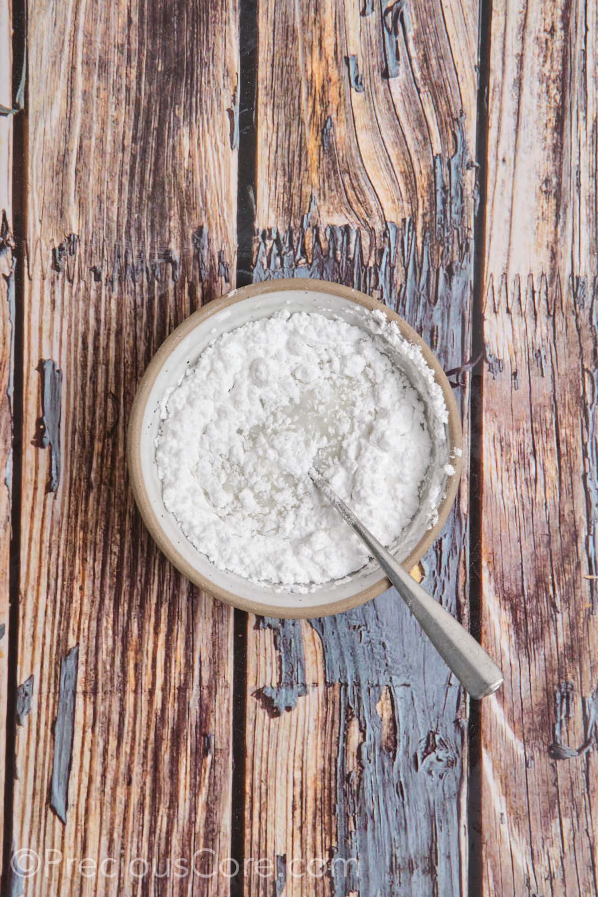 Preparing glaze with powdered sugar and milk.