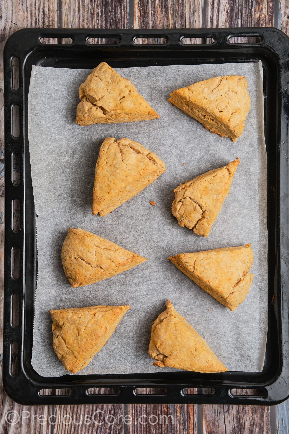 Baked sweet potato scones on a baking sheet.