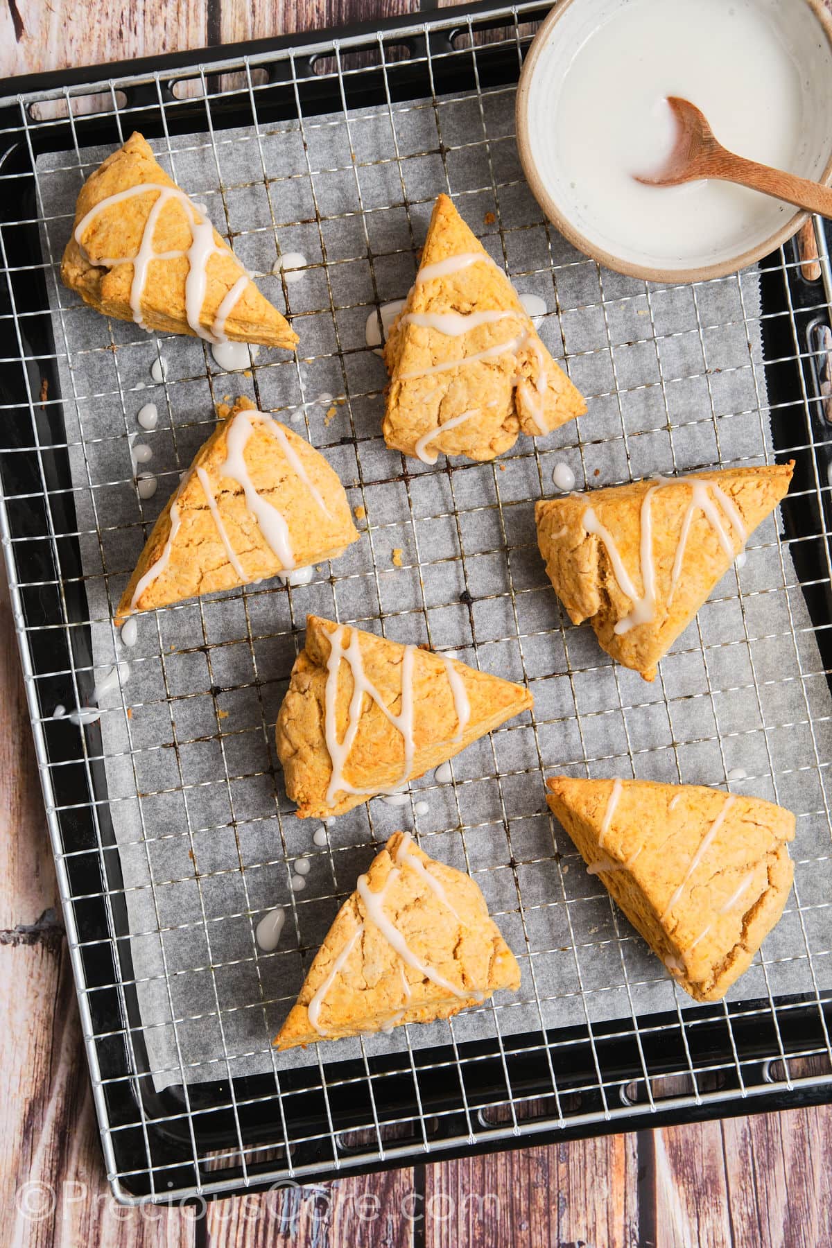 Scones with glaze drizzled on them.