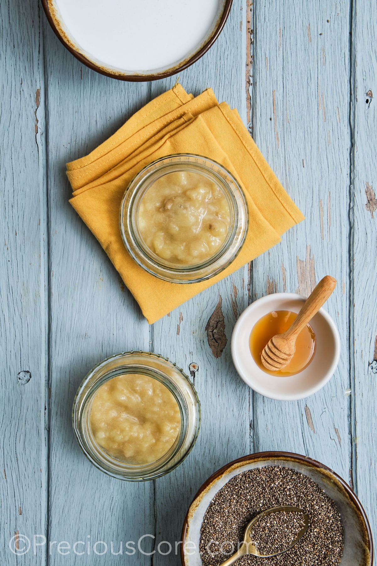 Adding mashed bananas to glass jars.