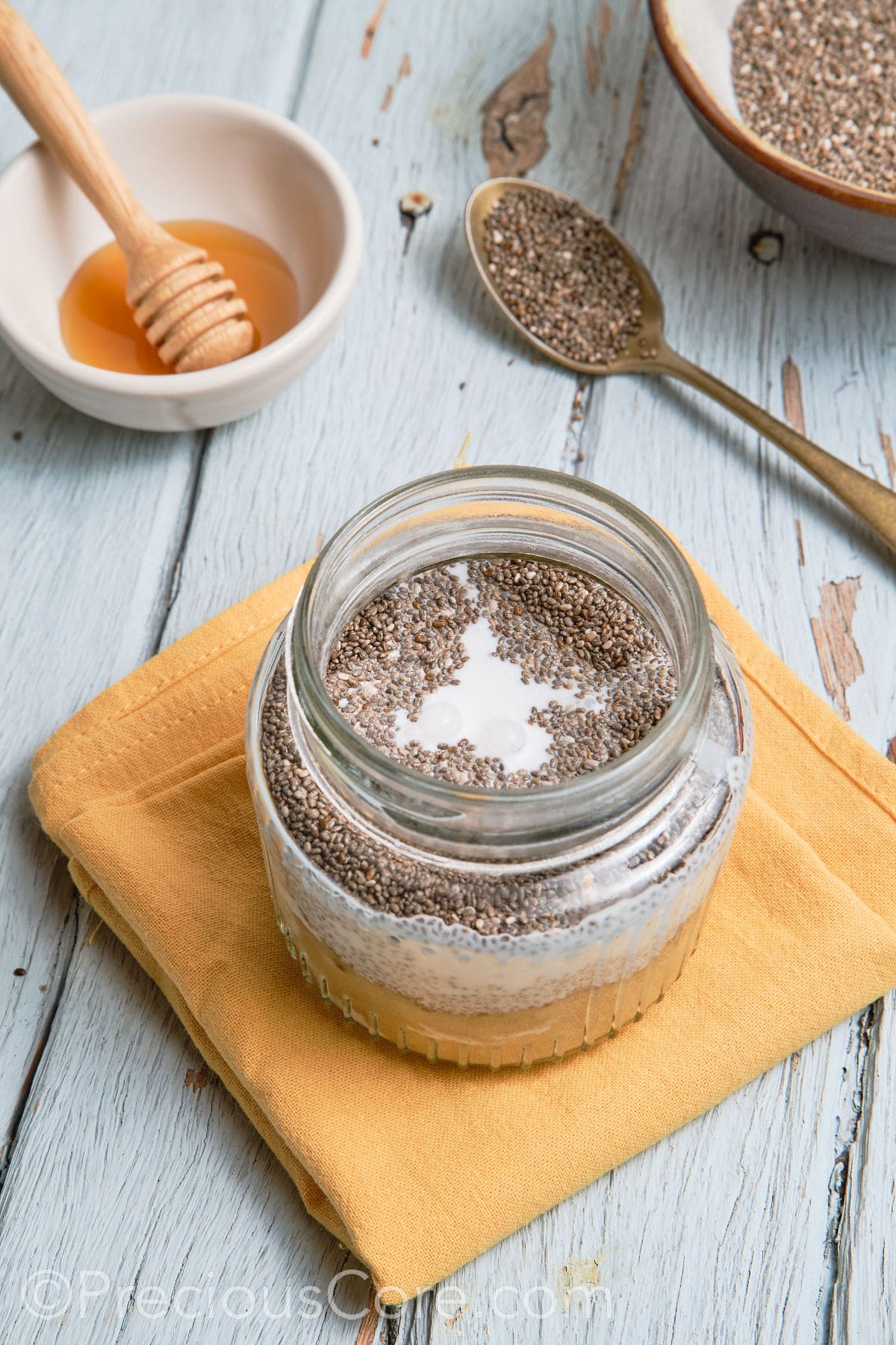 Chia pudding mixture in glass jar.