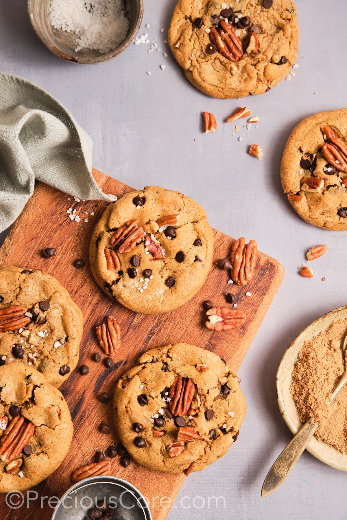 Cooled butter pecan cookies on a chopping board.