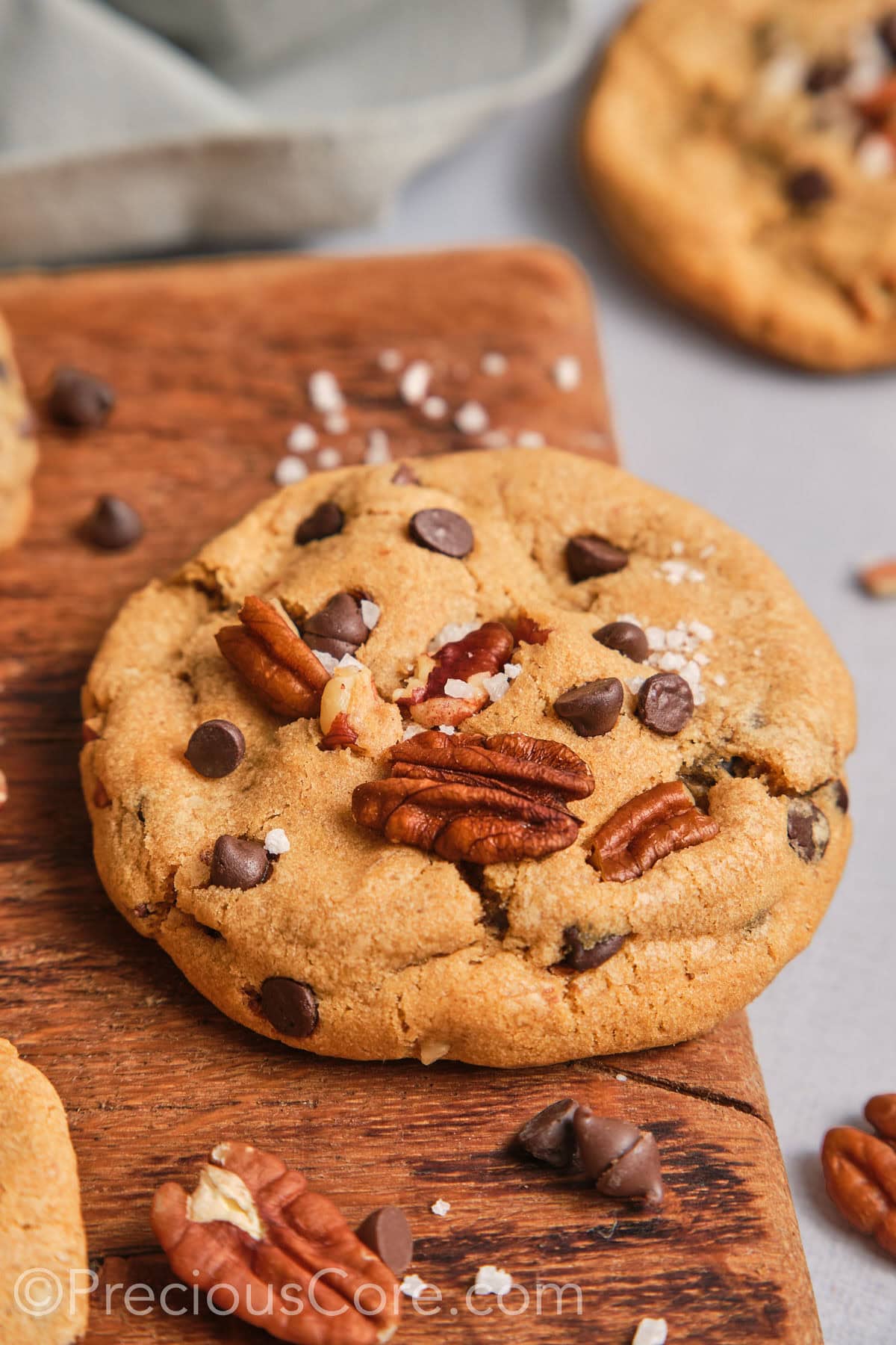 Close up on a large brown butter pecan cookie.