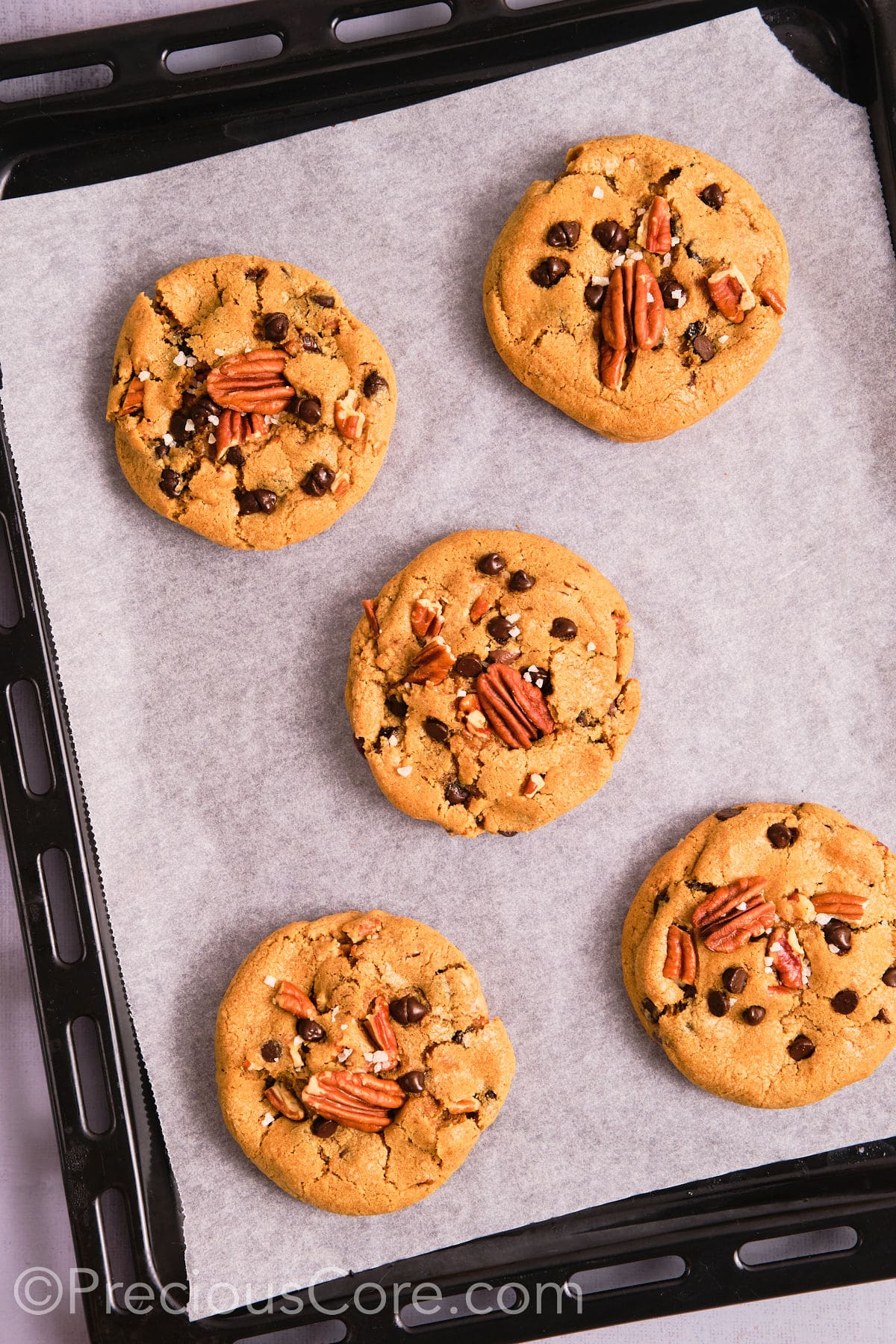 Perfectly baked brown butter pecan cookies on a baking sheet. 