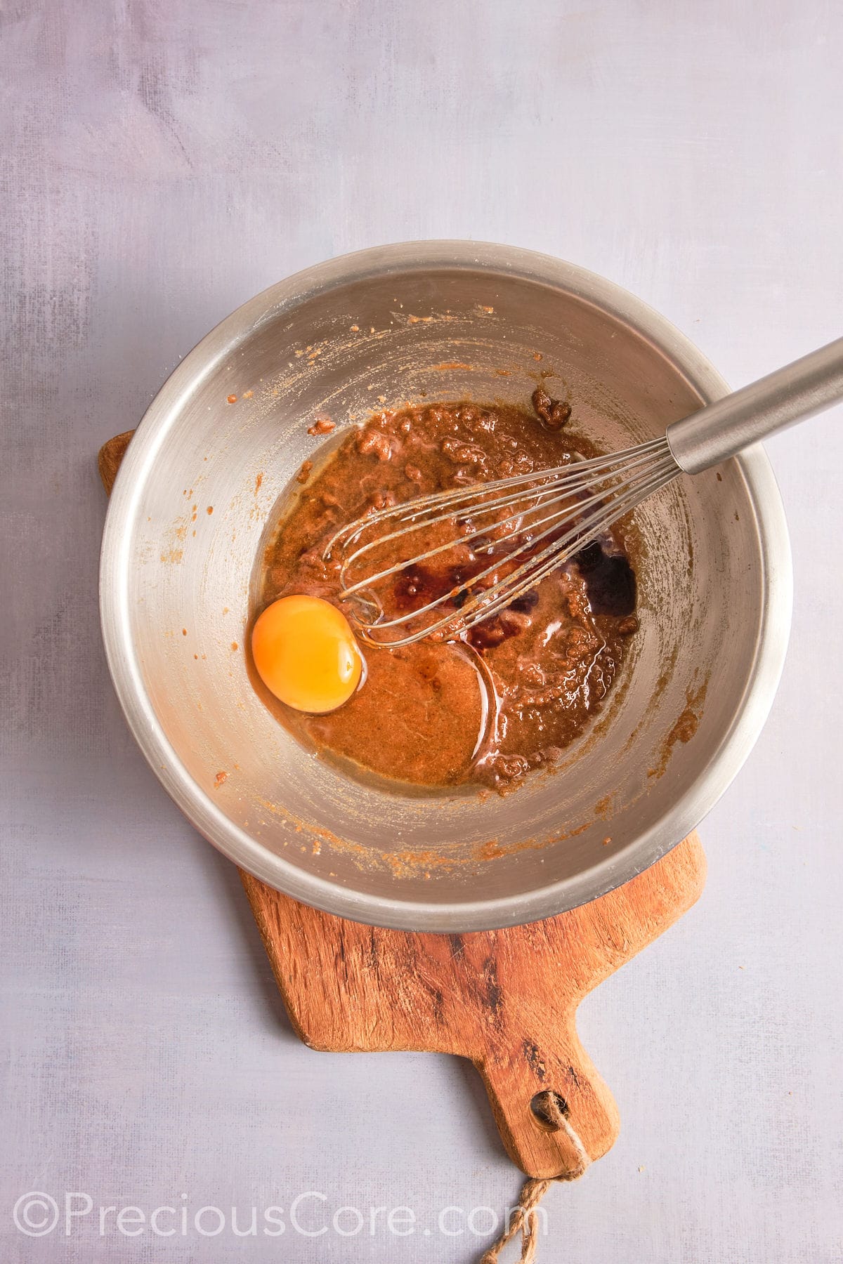 Adding egg and vanilla to the brown butter mixture. 