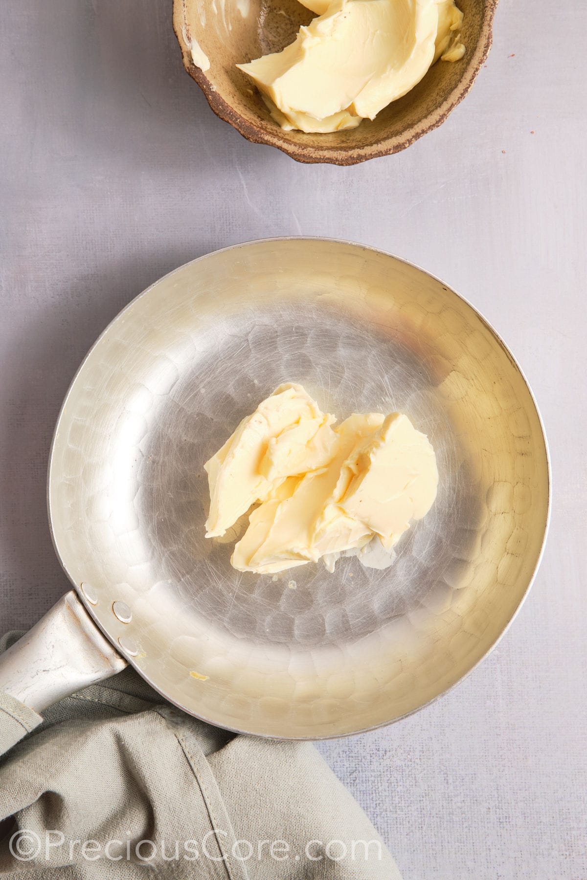 Butter in a pan about to melt and brown.