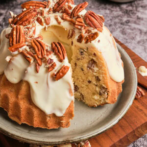 Butter pecan pound cake with a slice taken out.