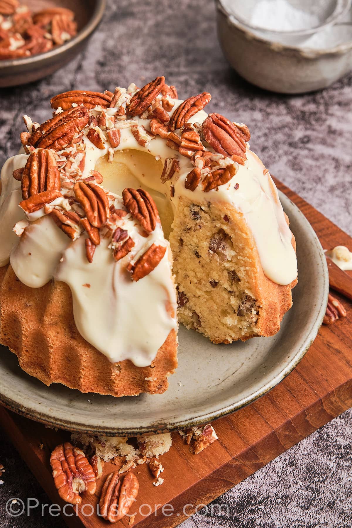 Butter pecan pound cake with a slice taken out.