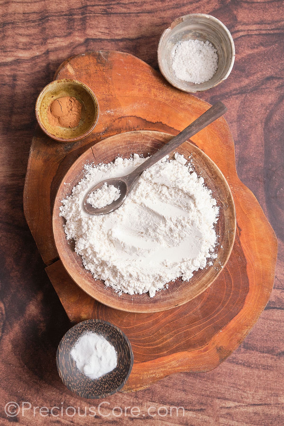 In a mixing bowl, take flour, baking soda, baking powder, salt, and cinnamon 