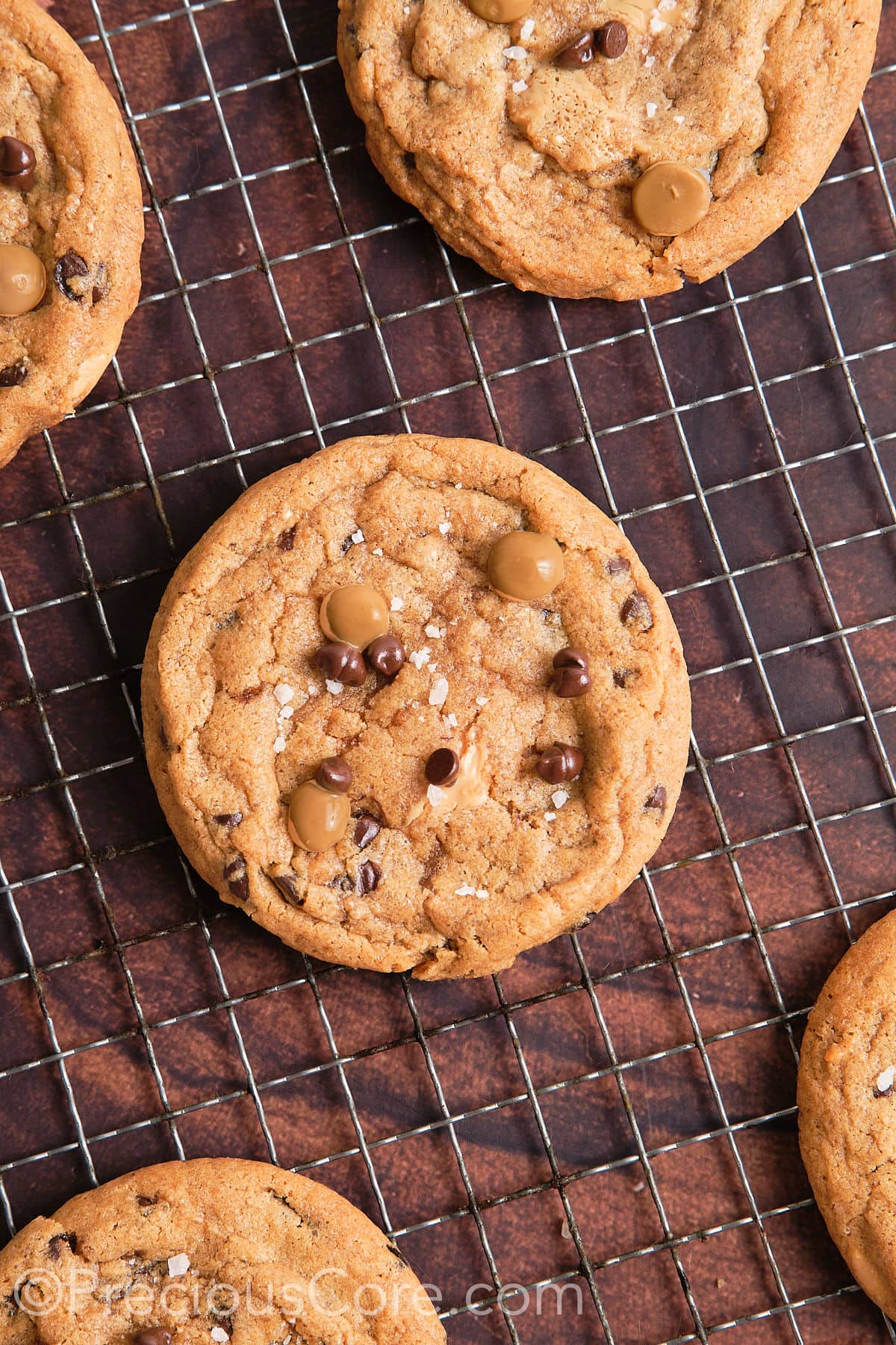 Butterscotch chip chocolate chip cookies on a cooling rack.