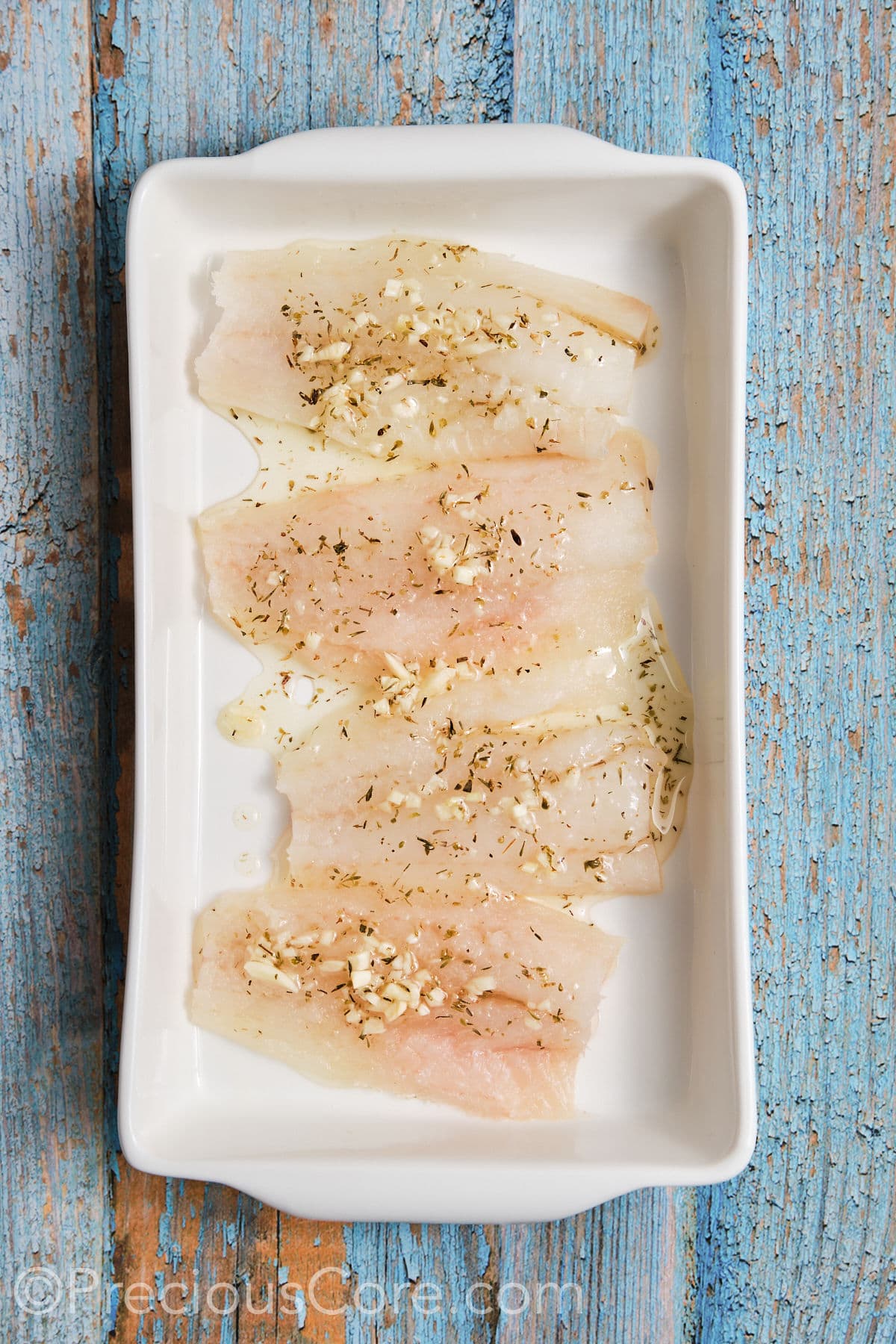 Cod fillets marinated in a pan. 