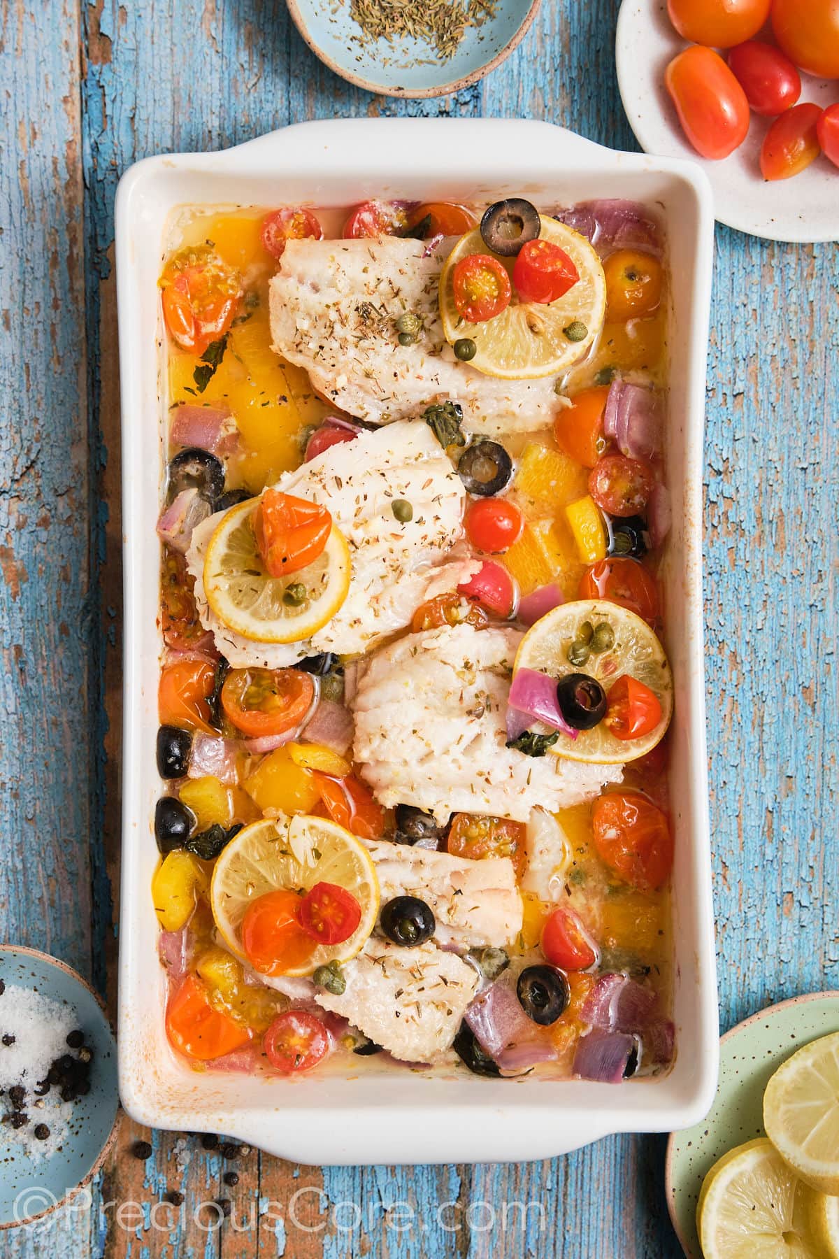 Baked Mediterranean fish and veggies in a pan. 