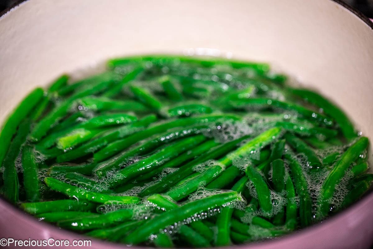 Green beans in a pot with water.