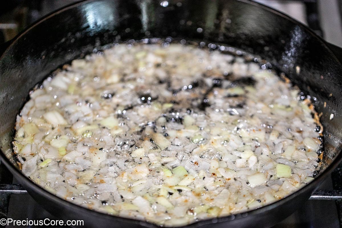 Onions sautéing in cast iron skillet.