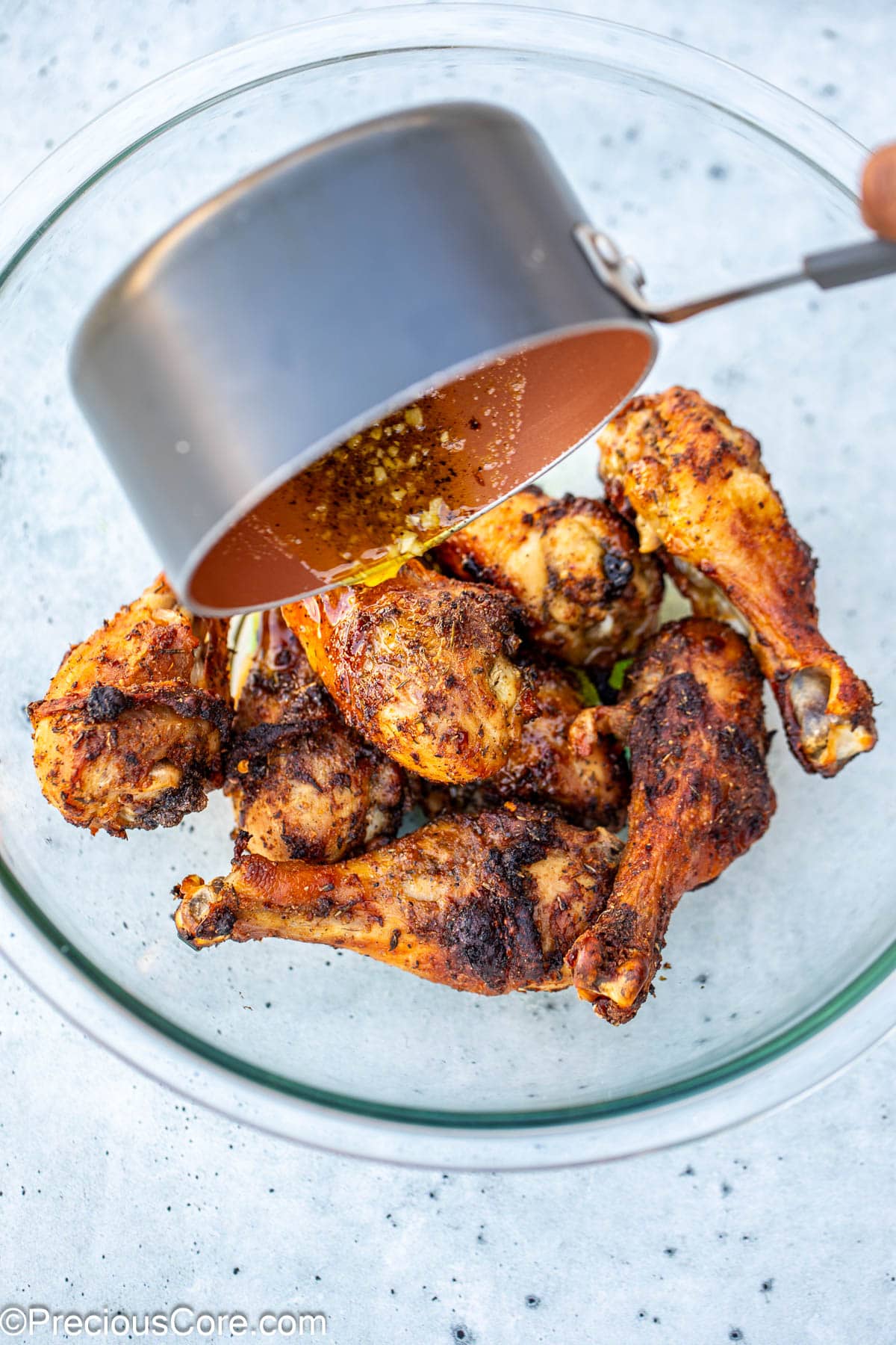 Lemon butter sauce being added to chicken.