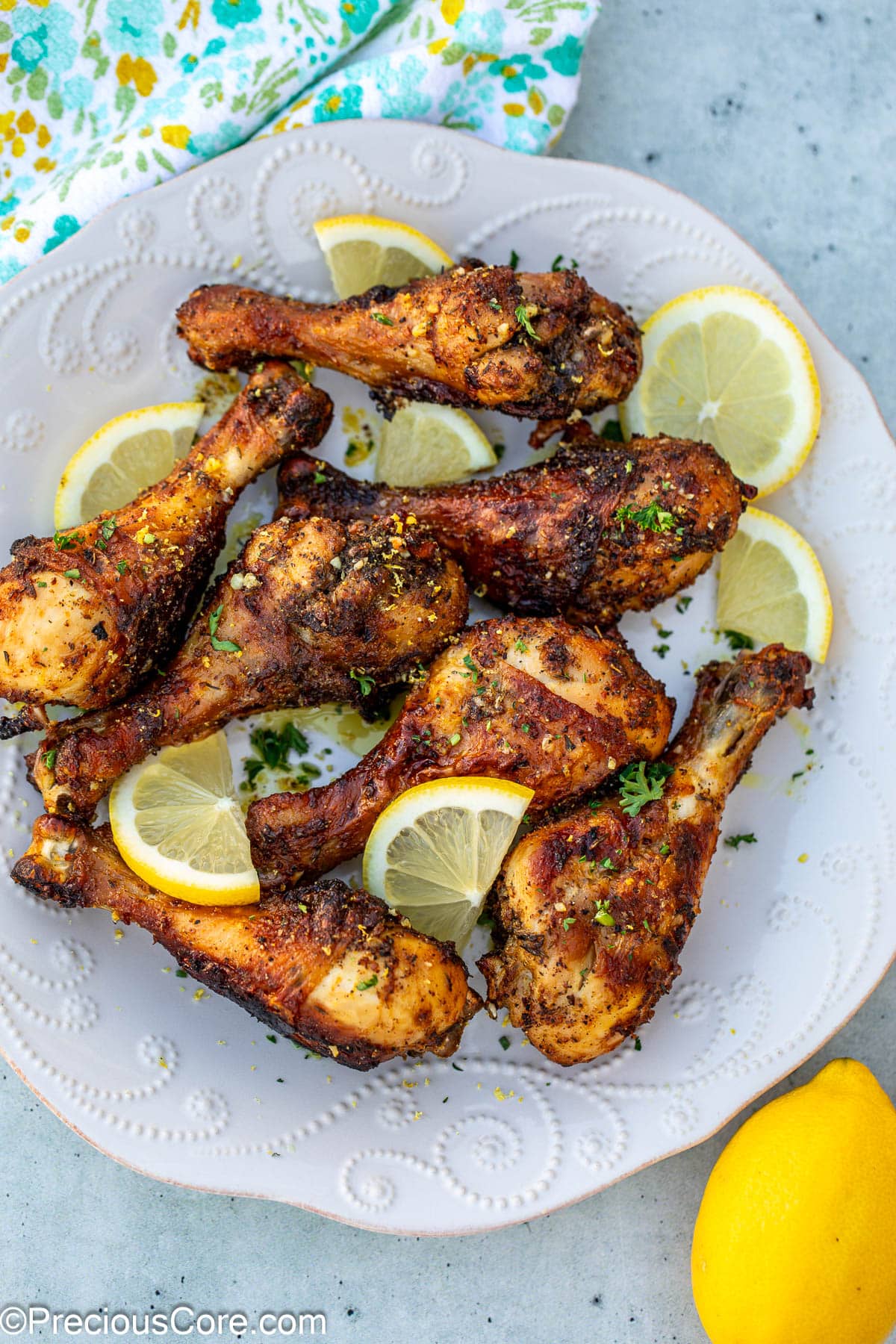 Cooked lemon pepper chicken garnished with parsley and lemon slices.